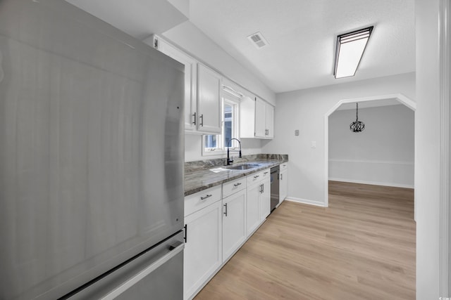 202 Berkshire Dr, Myrtle Beach, SC 29588 - kitchen featuring visible vents, a sink, dark stone counters, appliances with stainless steel finishes, and white cabinetry