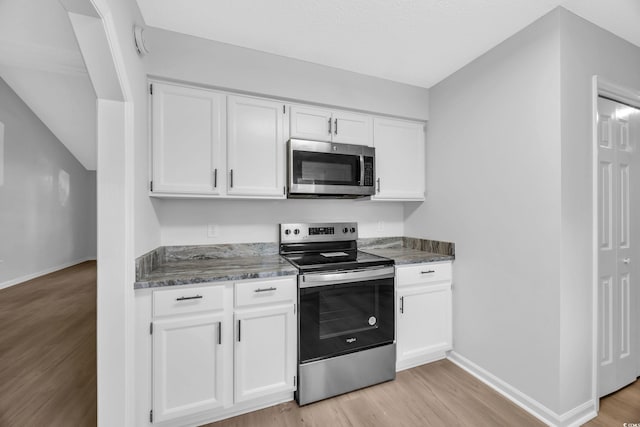 202 Berkshire Dr, Myrtle Beach, SC 29588 - kitchen with light wood-style flooring, appliances with stainless steel finishes, baseboards, and white cabinetry