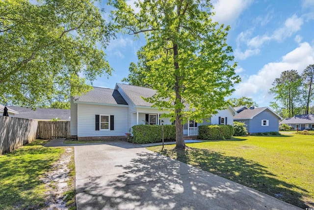 202 Berkshire Dr, Myrtle Beach, SC 29588 - view of front facade featuring fence, a shingled roof, a front yard, and concrete driveway