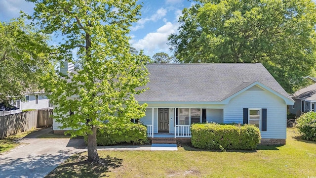 202 Berkshire Dr, Myrtle Beach, SC 29588 - view of front of property featuring a front lawn, fence, a shingled roof, and covered porch