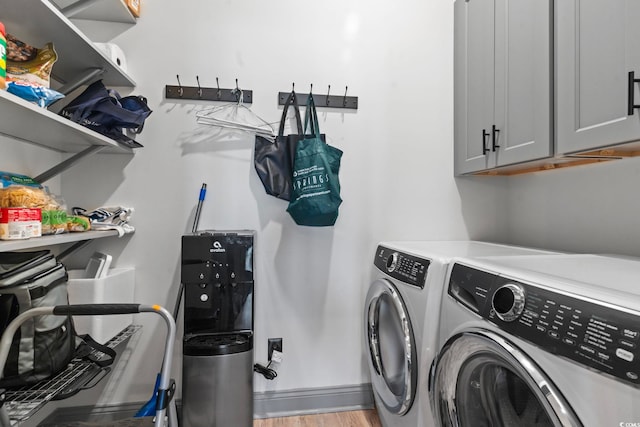 19 Red Skiff Ln Unit 15, Pawleys Island, SC 29585 - laundry room with separate washer and dryer, cabinet space, and light wood-type flooring