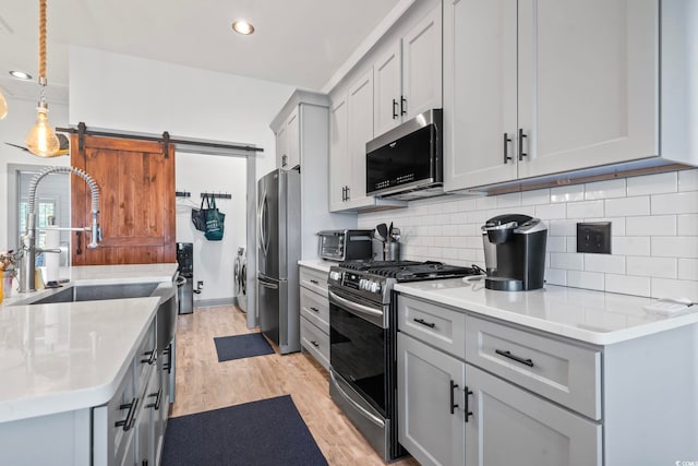 19 Red Skiff Ln Unit 15, Pawleys Island, SC 29585 - kitchen featuring appliances with stainless steel finishes, light wood-style floors, light countertops, and recessed lighting