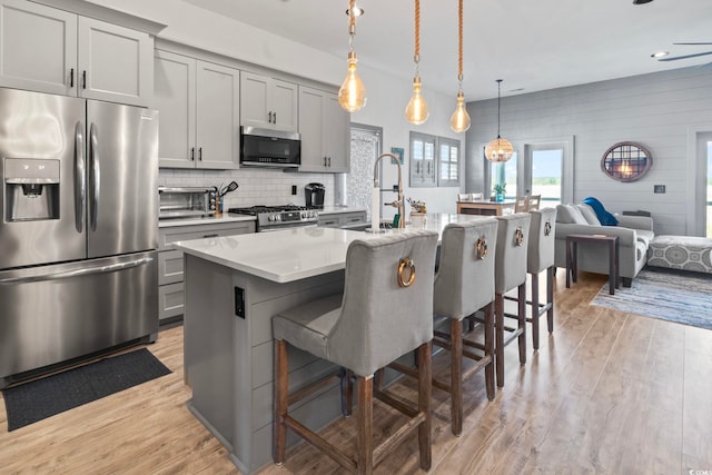 19 Red Skiff Ln Unit 15, Pawleys Island, SC 29585 - kitchen with appliances with stainless steel finishes, gray cabinets, light countertops, light wood-style flooring, and recessed lighting