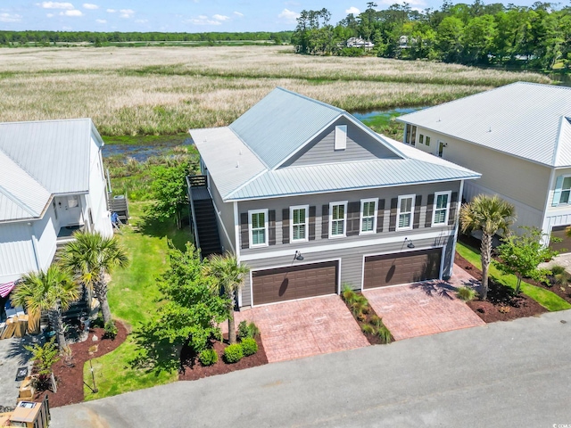 19 Red Skiff Ln Unit 15, Pawleys Island, SC 29585 - view of front of home featuring decorative driveway, a garage, and a metal roof