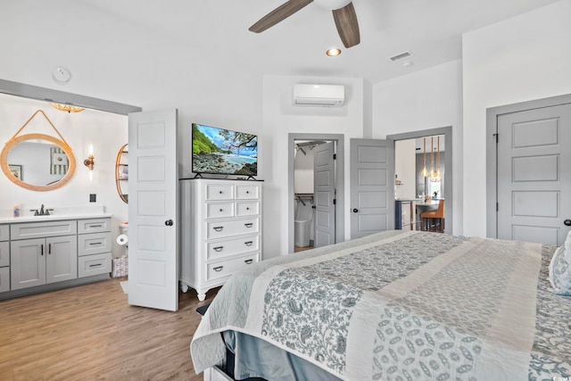 19 Red Skiff Ln Unit 15, Pawleys Island, SC 29585 - bedroom featuring an AC wall unit, light wood-style floors, ensuite bathroom, recessed lighting, and a ceiling fan