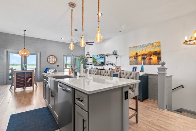 19 Red Skiff Ln Unit 15, Pawleys Island, SC 29585 - kitchen with stainless steel dishwasher, light wood finished floors, light countertops, and gray cabinetry