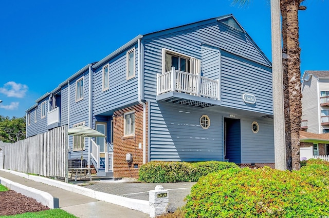 4504 S Ocean Blvd Unit A, North Myrtle Beach, SC 29582 - view of side of home featuring brick siding and a balcony