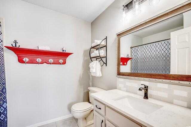 4504 S Ocean Blvd Unit A, North Myrtle Beach, SC 29582 - full bath featuring vanity, toilet, baseboards, tile patterned floors, and backsplash