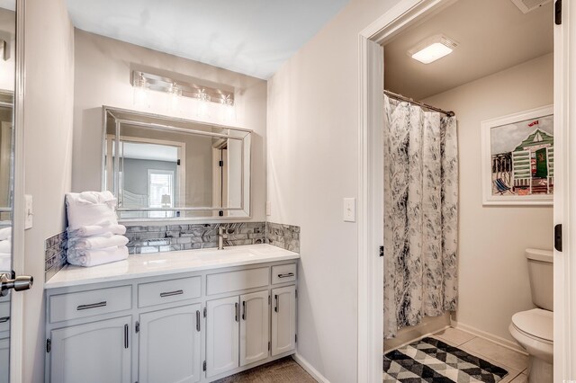 4504 S Ocean Blvd Unit A, North Myrtle Beach, SC 29582 - bathroom featuring vanity, a shower with curtain, toilet, and tasteful backsplash