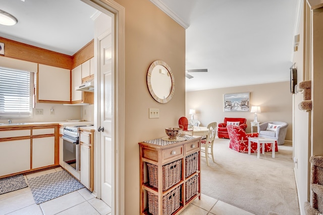 4504 S Ocean Blvd Unit A, North Myrtle Beach, SC 29582 - kitchen with open floor plan, white electric range oven, ceiling fan, light countertops, and light tile patterned floors