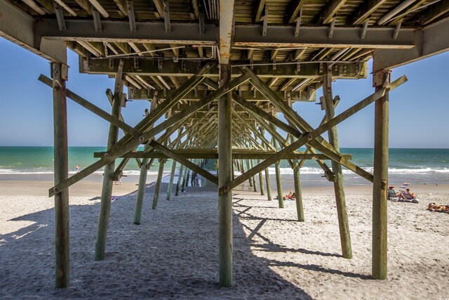 4504 S Ocean Blvd Unit A, North Myrtle Beach, SC 29582 - view of patio featuring a view of the beach, a pier, and a water view