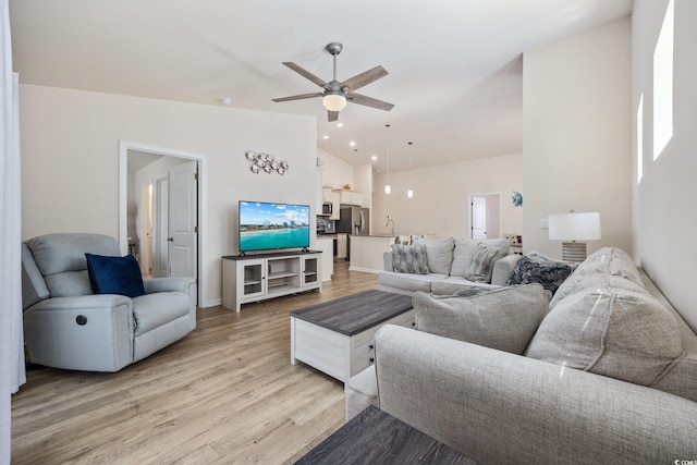 351 Logan St, Little River, SC 29566 - living room with vaulted ceiling, ceiling fan, light wood-style floors, and baseboards