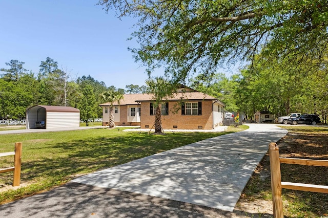 1869 Meadowood Ln, Longs, SC 29568 - view of front facade with a storage shed, a detached carport, concrete driveway, crawl space, and a front yard