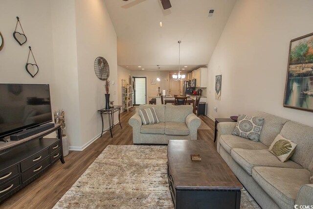 2005 Willow Run Dr Unit C, Little River, SC 29566 - living room featuring high vaulted ceiling, ceiling fan with notable chandelier, baseboards, dark wood-style flooring, and visible vents