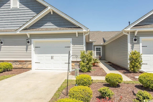 2005 Willow Run Dr Unit C, Little River, SC 29566 - view of front of home featuring driveway, stone siding, and a garage