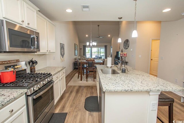 2005 Willow Run Dr Unit C, Little River, SC 29566 - kitchen with a kitchen breakfast bar, a sink, light wood-style floors, stainless steel appliances, and visible vents