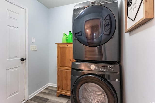 7011 Blade Beak Ln, Myrtle Beach, SC 29588 - laundry area with stacked washer and dryer, baseboards, wood finished floors, and cabinet space