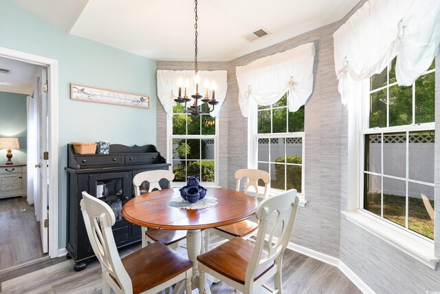 7011 Blade Beak Ln, Myrtle Beach, SC 29588 - dining area featuring baseboards, a notable chandelier, wood finished floors, and visible vents
