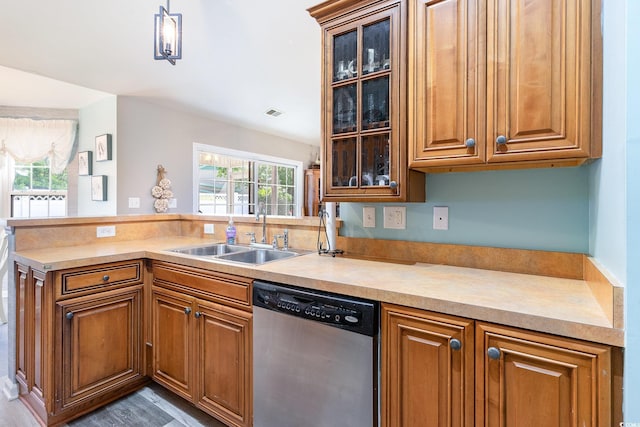7011 Blade Beak Ln, Myrtle Beach, SC 29588 - kitchen with a peninsula, dishwasher, a sink, and brown cabinetry