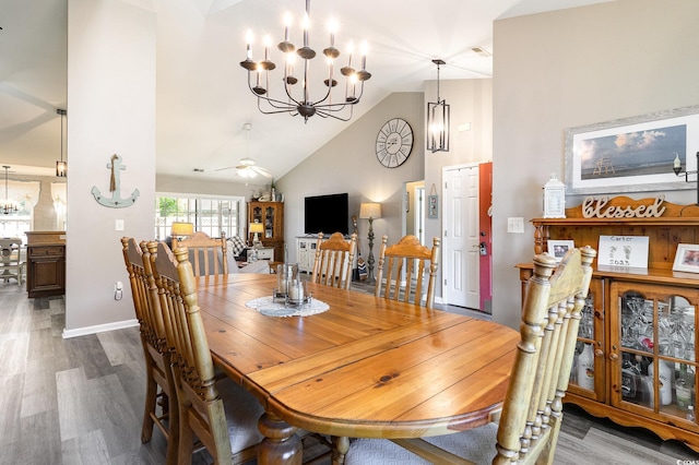 7011 Blade Beak Ln, Myrtle Beach, SC 29588 - dining area featuring ceiling fan with notable chandelier, baseboards, wood finished floors, and high vaulted ceiling