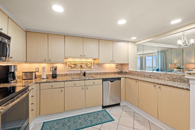 9840 Queensway Blvd Unit 1007, Myrtle Beach, SC 29572 - kitchen with appliances with stainless steel finishes, cream cabinets, light stone counters, light tile patterned floors, and recessed lighting