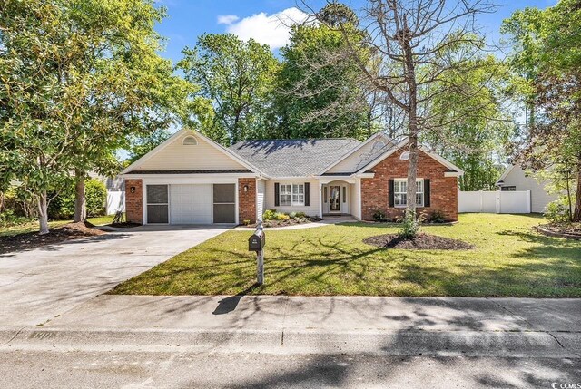 130 Ashton Cir, Myrtle Beach, SC 29588 - ranch-style home with fence, concrete driveway, an attached garage, brick siding, and a front yard
