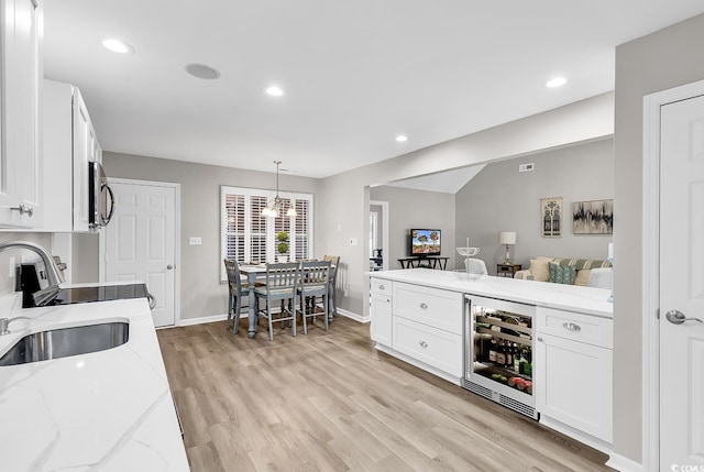 130 Ashton Cir, Myrtle Beach, SC 29588 - bar featuring light wood finished floors, wine cooler, a sink, a chandelier, and appliances with stainless steel finishes