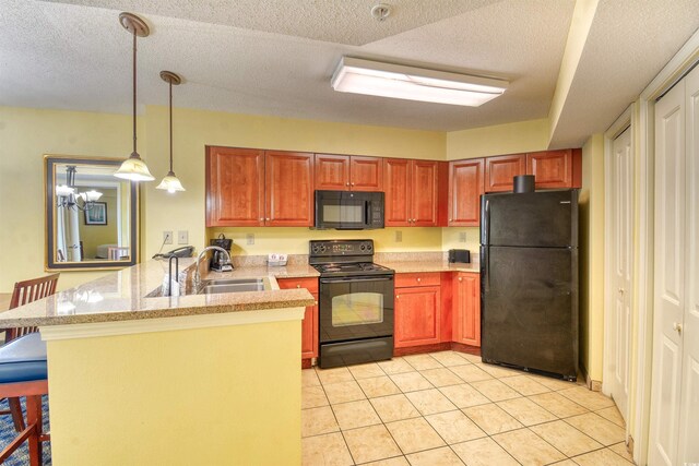 5300 N Ocean Blvd Unit 923, Myrtle Beach, SC 29577 - kitchen featuring a peninsula, a breakfast bar, light tile patterned flooring, a textured ceiling, and black appliances