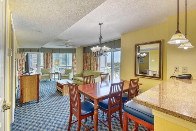 5300 N Ocean Blvd Unit 923, Myrtle Beach, SC 29577 - dining space with a textured ceiling, carpet floors, and ceiling fan with notable chandelier