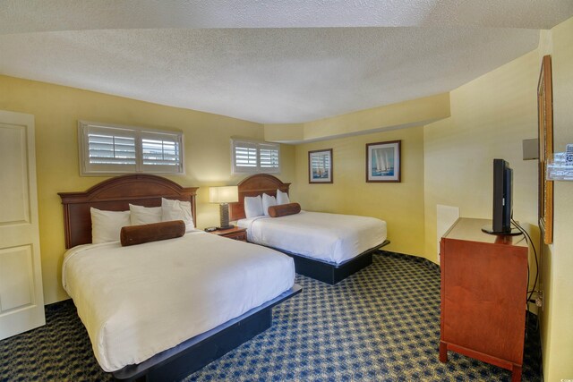 5300 N Ocean Blvd Unit 923, Myrtle Beach, SC 29577 - bedroom with a textured ceiling and carpet floors