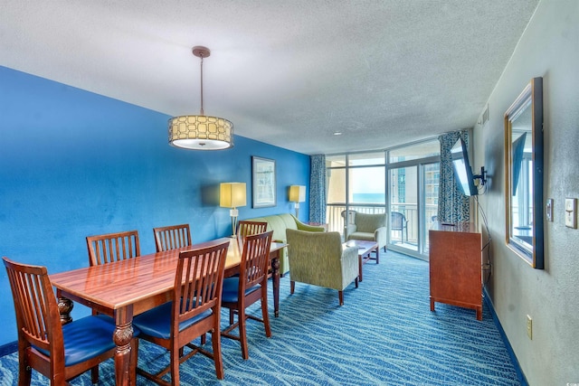 carpeted dining room with a textured ceiling, a textured wall, a wall of windows, and visible vents