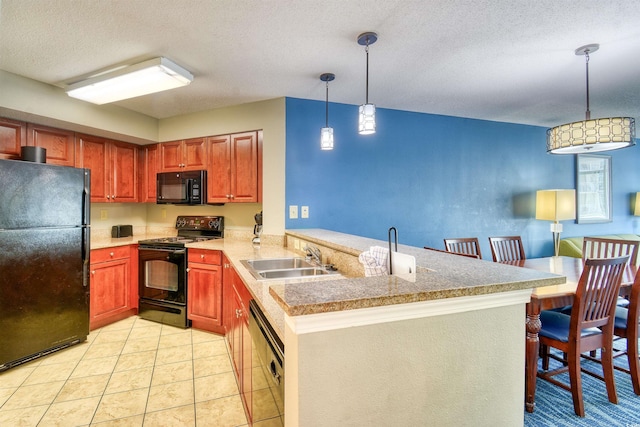kitchen with a sink, a peninsula, a textured ceiling, black appliances, and pendant lighting