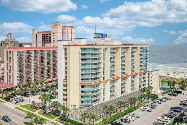 view of building exterior featuring a water view and a city view