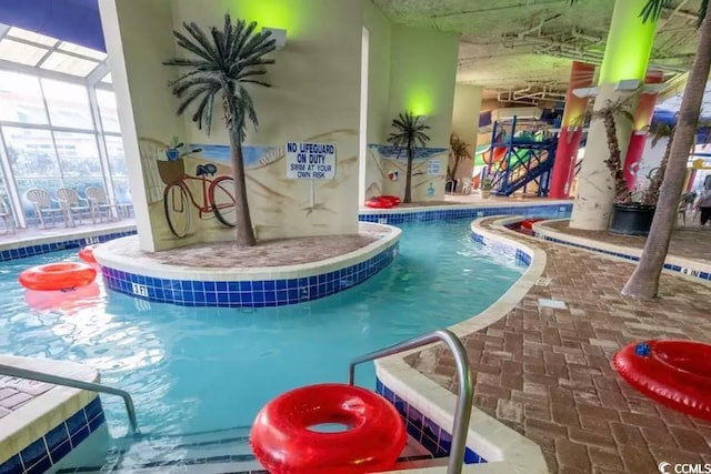 community pool featuring a hot tub