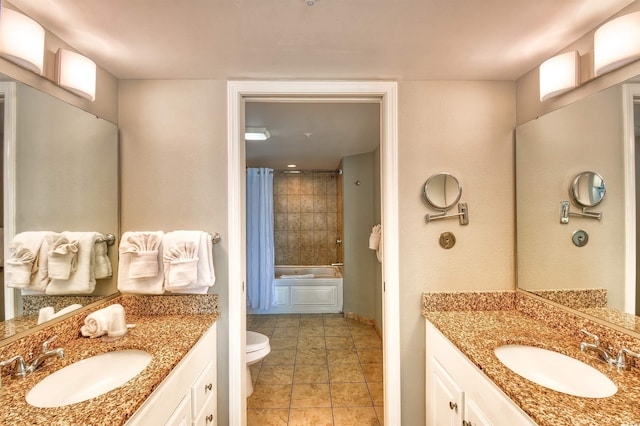 bathroom with a sink, tile patterned flooring, and two vanities
