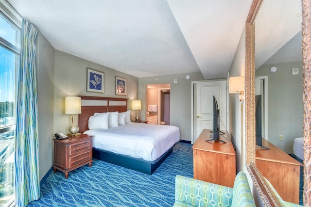 carpeted bedroom with baseboards and multiple windows