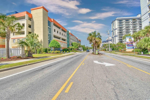 view of street with street lights, curbs, and sidewalks