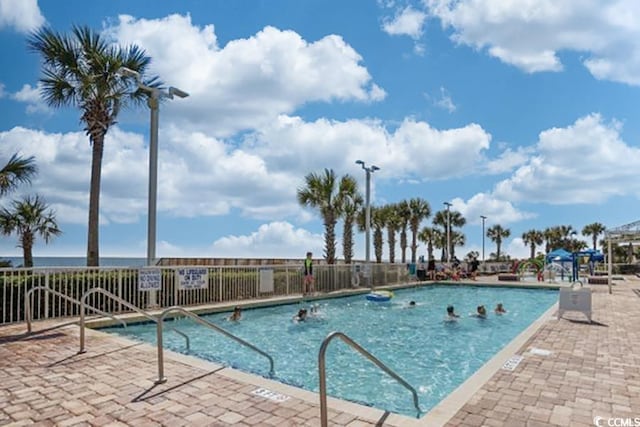 community pool featuring a patio and fence