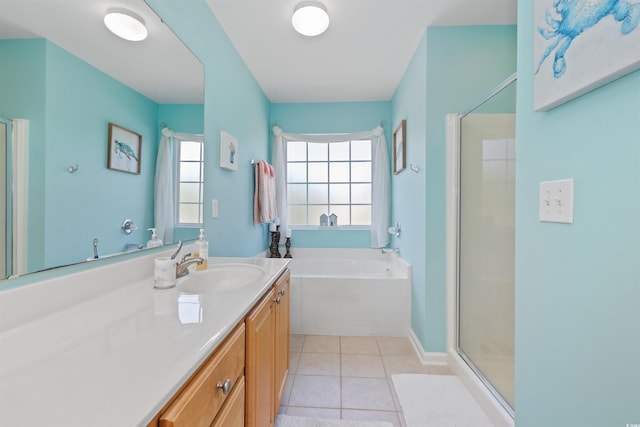 bathroom featuring a stall shower, vanity, a bath, and tile patterned floors