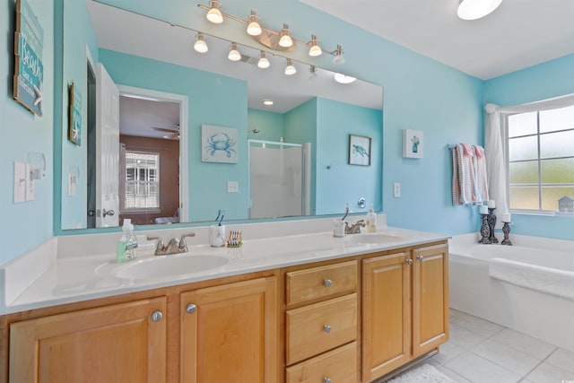 full bath with tile patterned floors, double vanity, a shower stall, and a sink