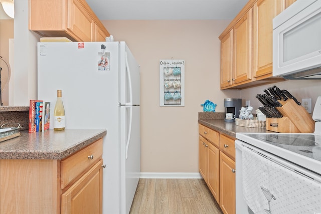 kitchen with baseboards, white appliances, light brown cabinetry, and light wood-style flooring