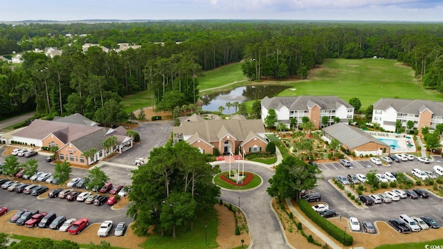 bird's eye view featuring view of golf course, a water view, and a forest view