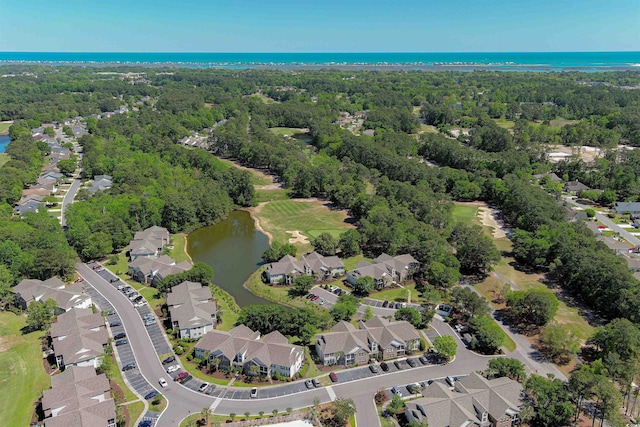 bird's eye view with a water view, a wooded view, and a residential view