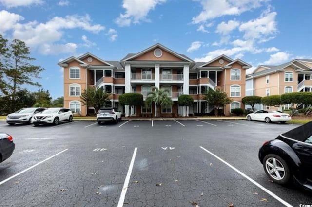 view of property with uncovered parking
