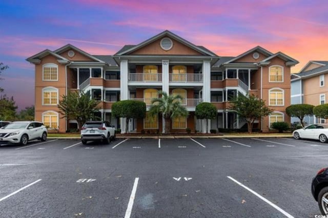 view of property featuring uncovered parking