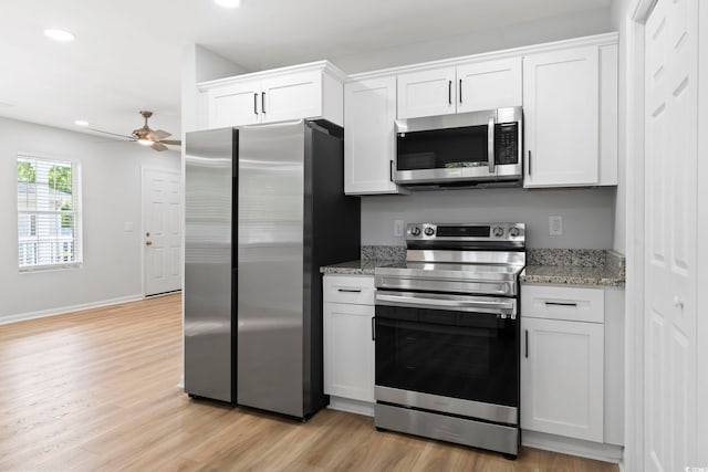 kitchen featuring a ceiling fan, light wood-type flooring, and appliances with stainless steel finishes