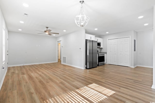 unfurnished living room featuring visible vents, baseboards, and recessed lighting