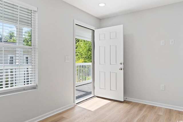 entrance foyer featuring baseboards, light wood-style flooring, and recessed lighting