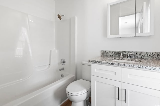 bathroom featuring toilet, bathing tub / shower combination, and vanity