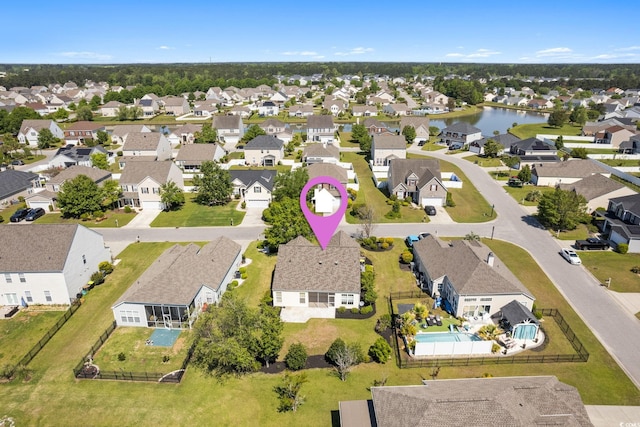 aerial view of residential area featuring a large body of water